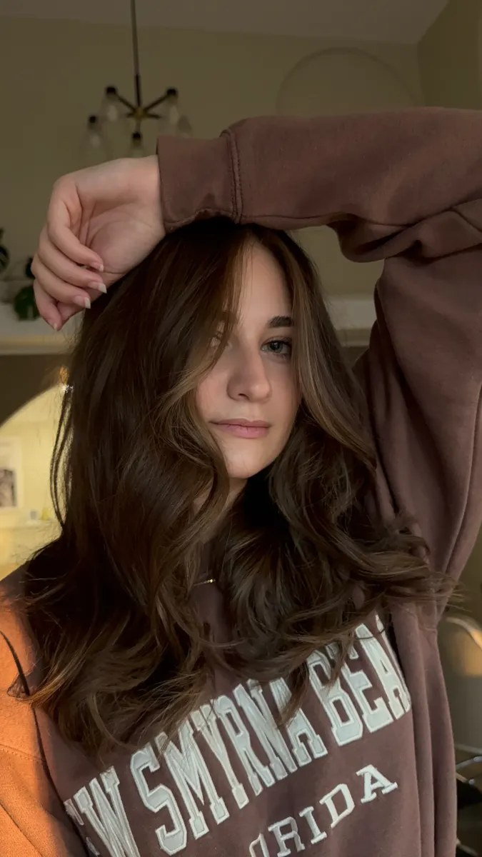 Medium length brown hair with honey blonde highlights and loose waves