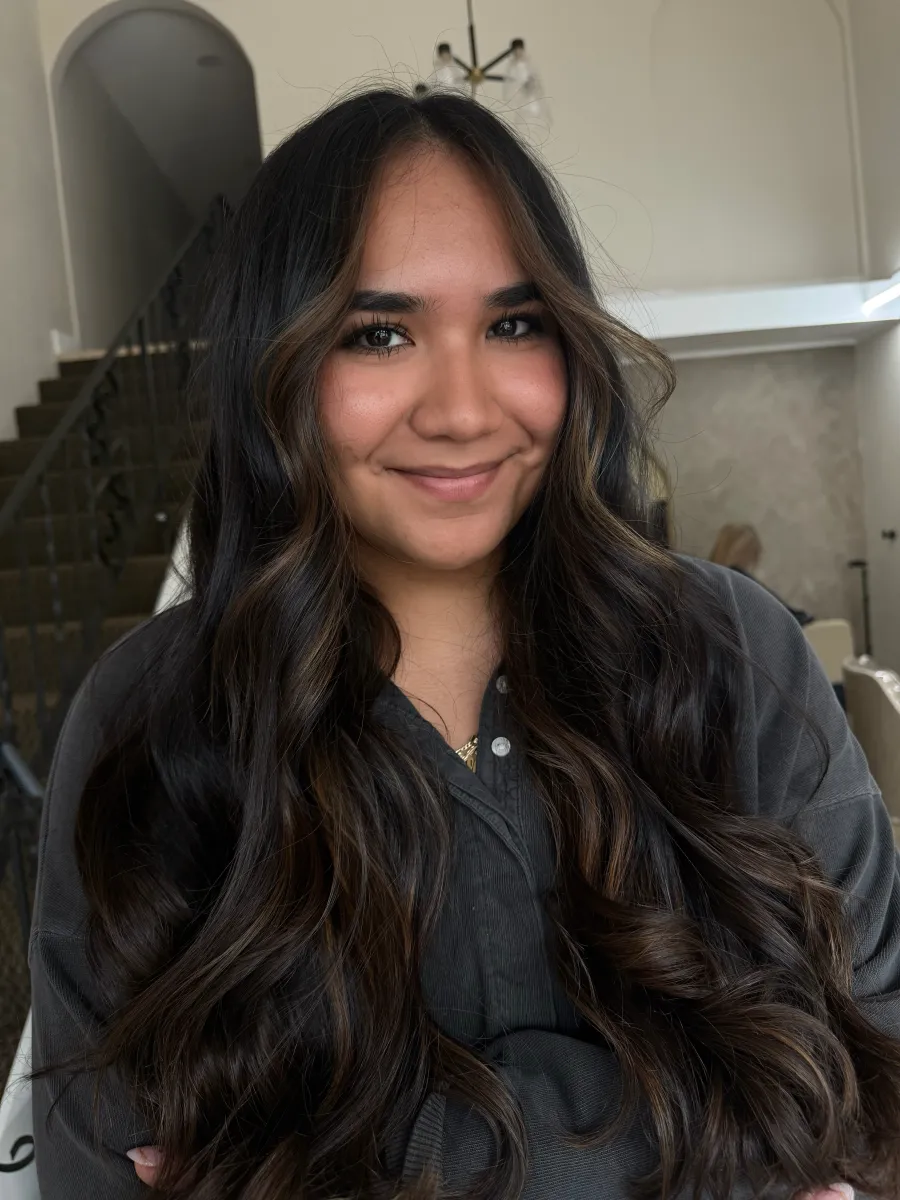Dark brunette hair with caramel highlights and voluminous curls