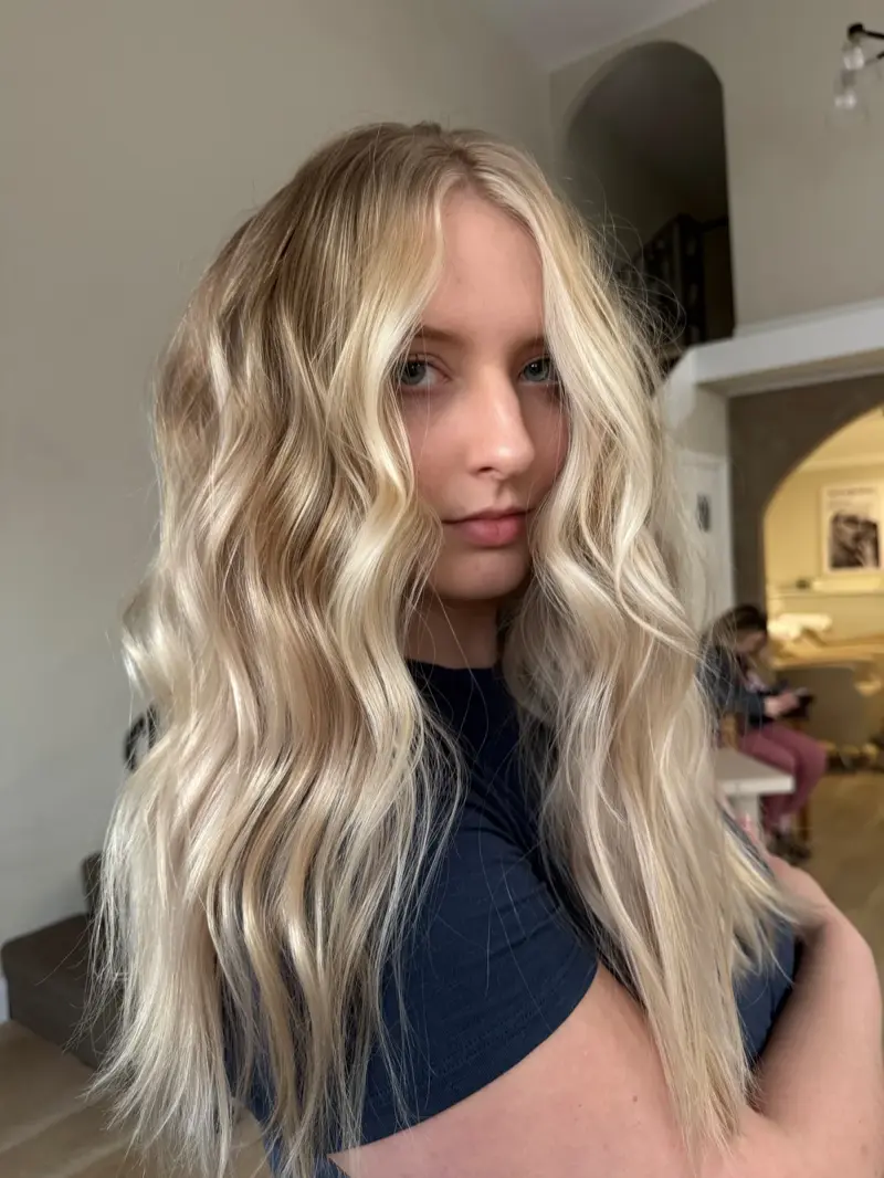 Long platinum blonde hair with ash tones and beachy waves