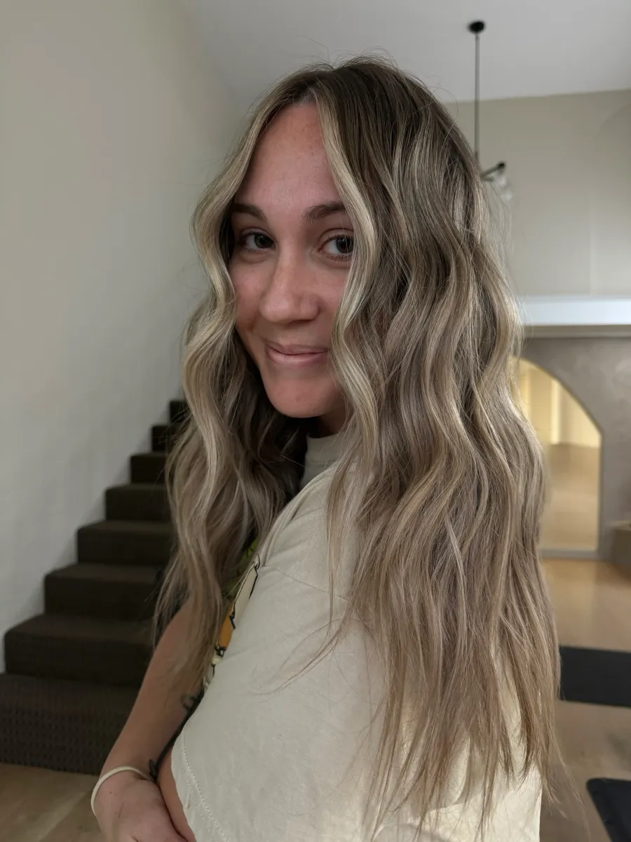 Long blonde balayage hair with beach waves and dimensional highlights